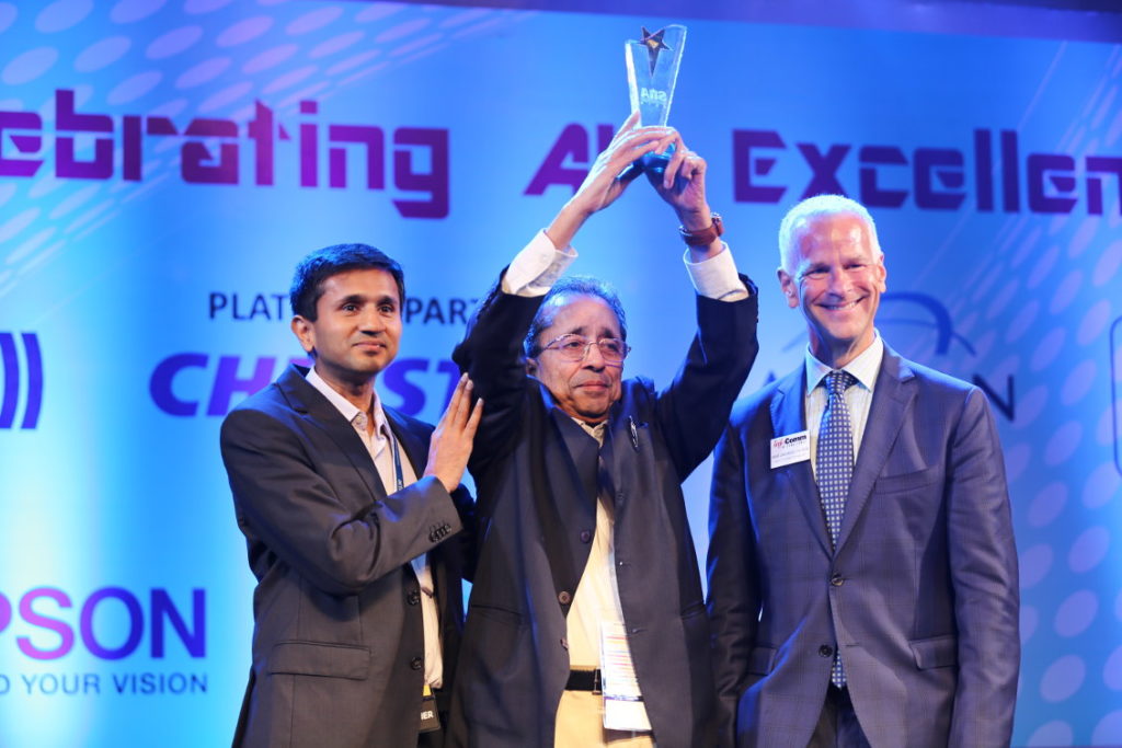 Manmohan Gupta, Founder of Actis Technologies, presented with the Lifetime Achievement Award for “The Most Distinguished Visionary in Systems Integration in India.” Presenting the award was David Labuskes, Executive Director and CEO of InfoComm International. At the side of Mr Gupta, is his son Abhimanyu